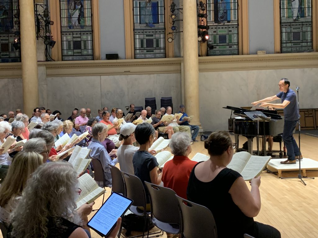 Conductor leading Singers